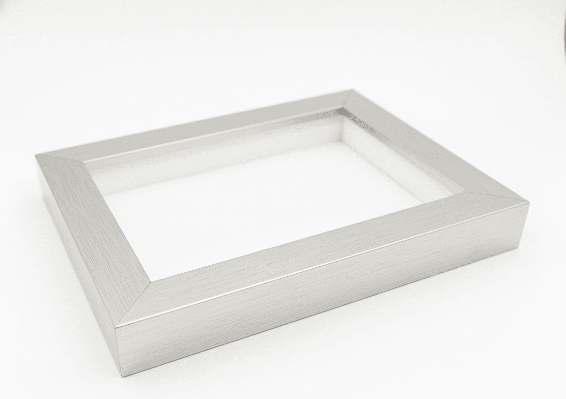 Professional product photography of empty brushed silver shadowbox frame on white background showing clean modern design 1 inch moulding width and 1.5 inch depth capacity demonstrating quality deep picture frame construction for custom dimensional framing