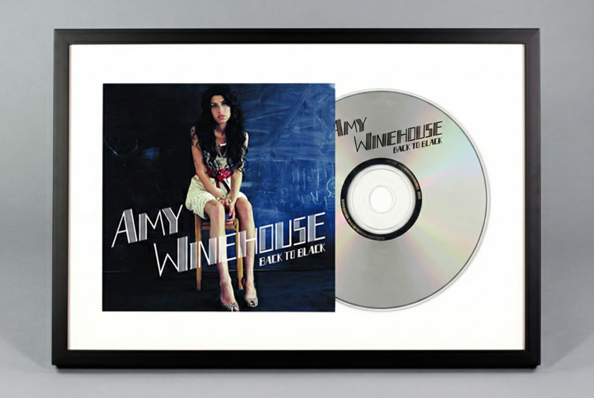 CD frame with shadowbox depth displaying both jewel case artwork and disc in home office